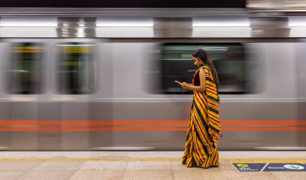 Young Indian woman waiting for a train at subway station, India